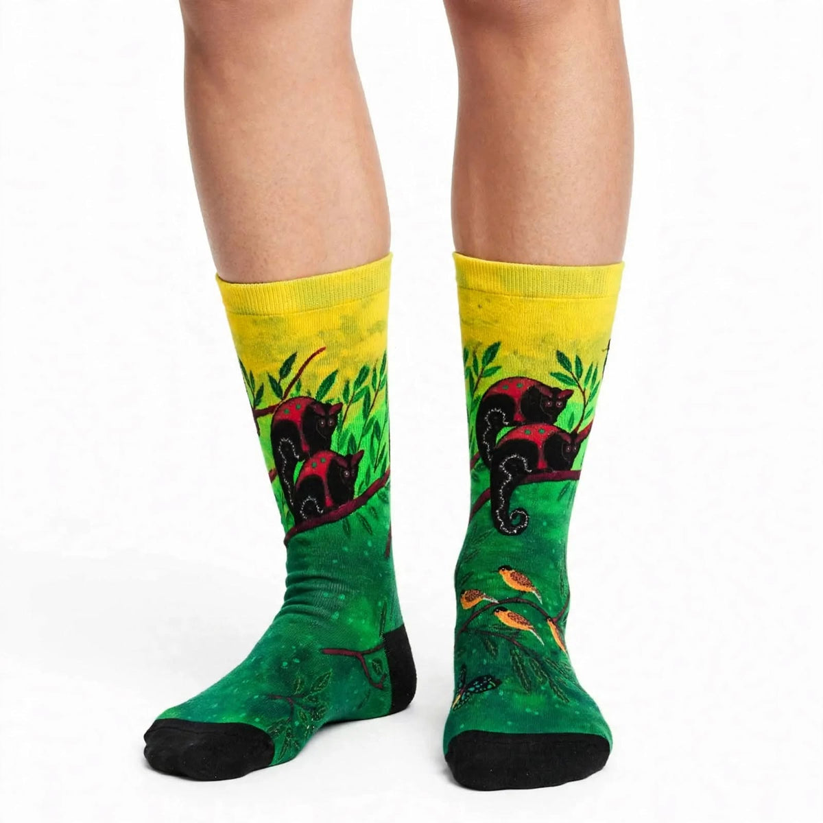 Canopy Encounters by Melanie Hava: yellow and green canopy-print bamboo socks worn on feet, front view.