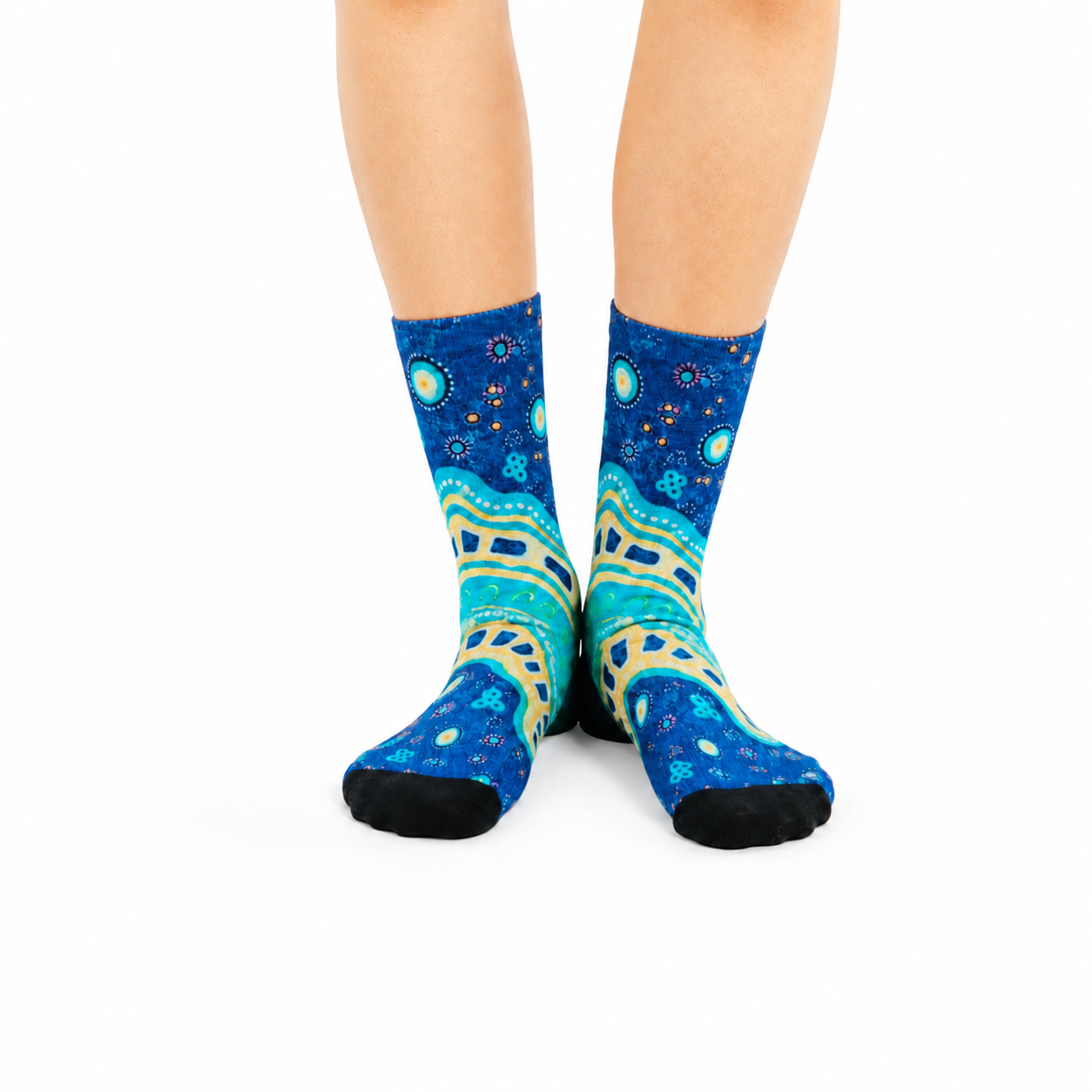 Colourful bamboo socks featuring Indigenous Australian Aboriginal artwork on a blue background.
