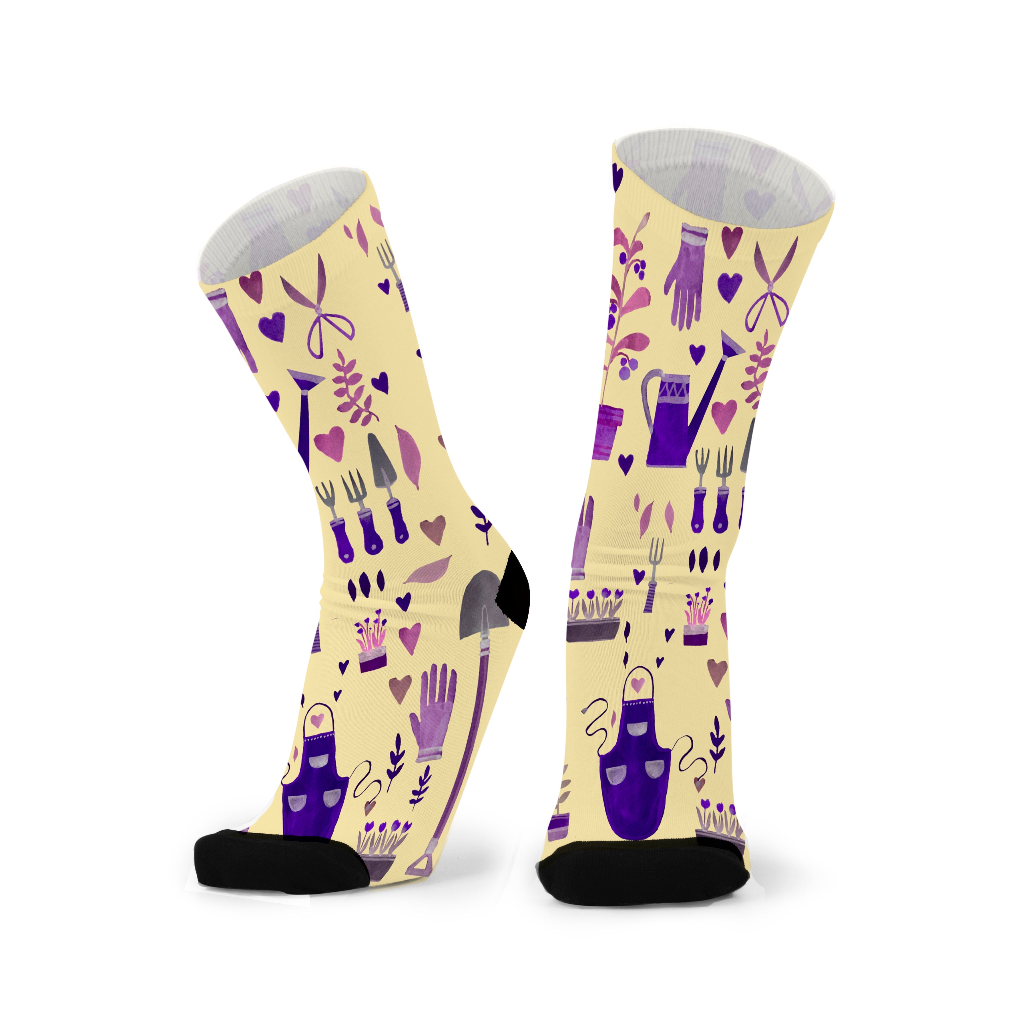 Colourful bamboo socks featuring plants, flowers and gardening tools on a yellow background.