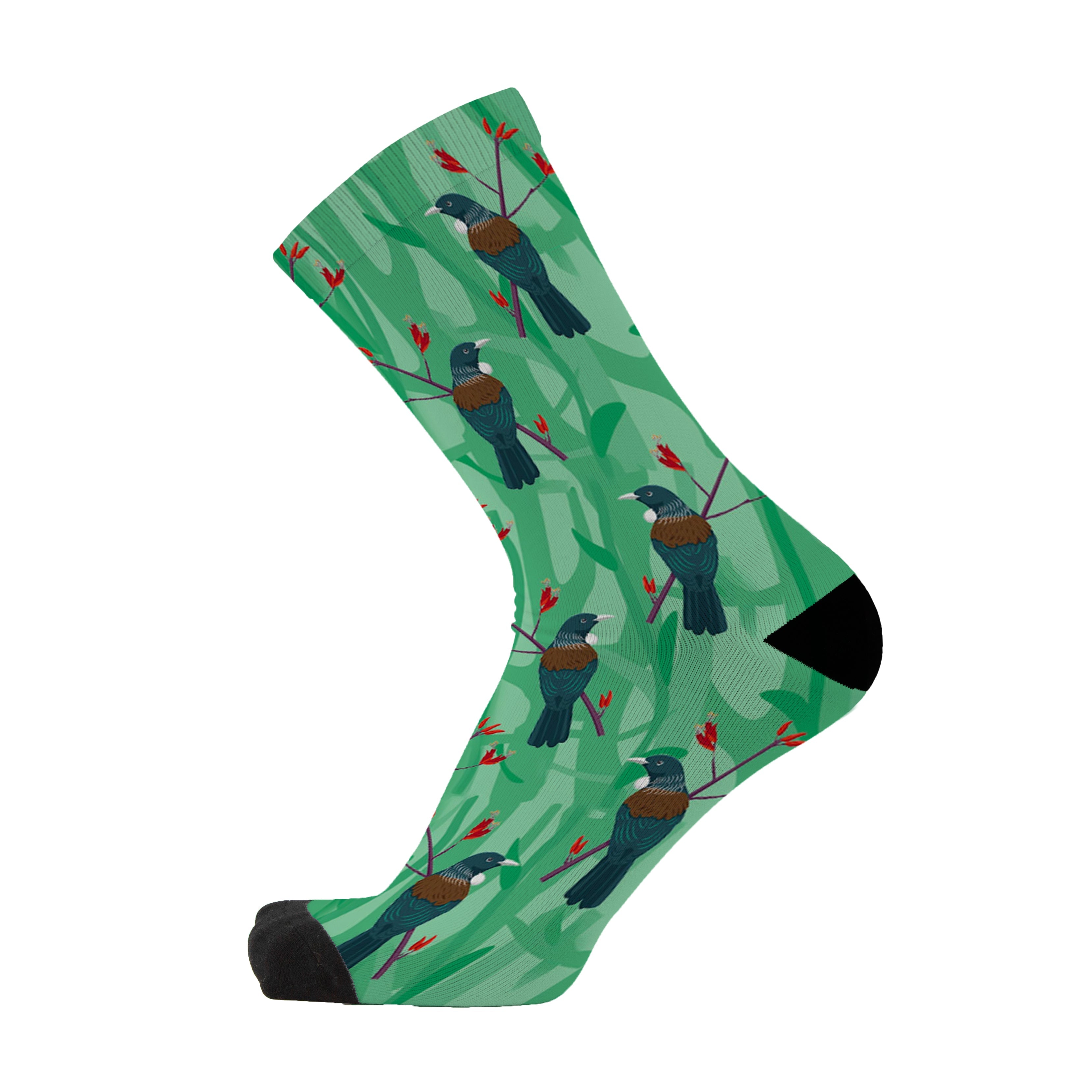 Colourful bamboo socks featuring Tūītohi birds from New Zealand on a green background.