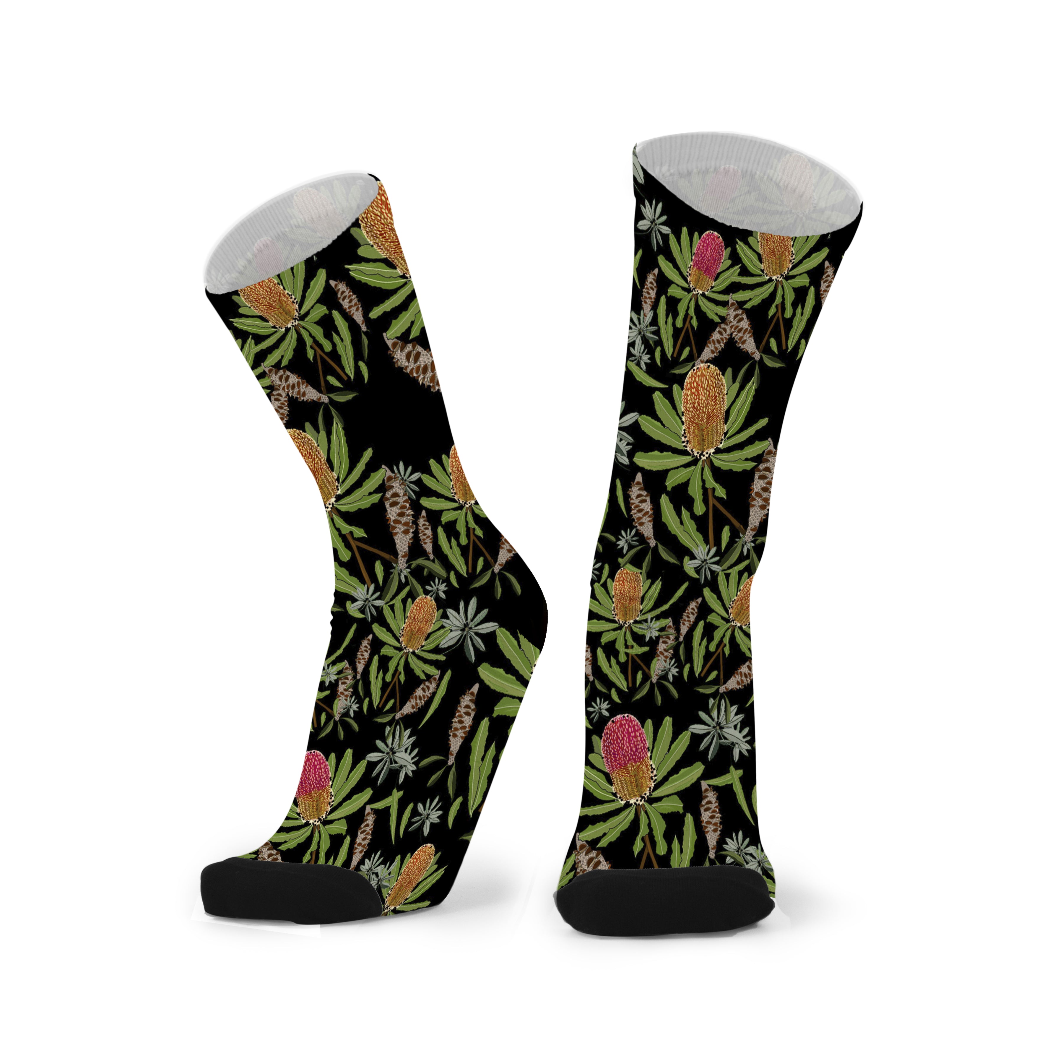 Black bamboo socks featuring Australian Banksia flowers and native foliage with premium botanical illustration.