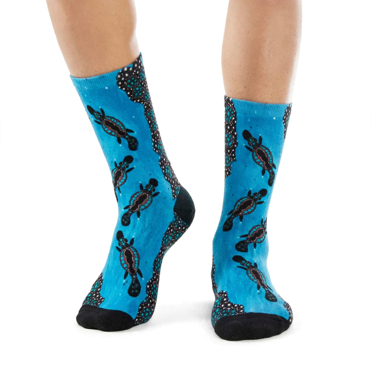 Platypus Race by Melanie Hava: turquoise platypus-print bamboo socks worn on feet.
