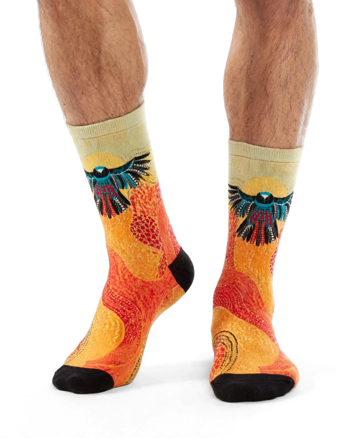 Eagle Soaring by Melanie Hava: orange and yellow eagle-print bamboo socks worn on feet.
