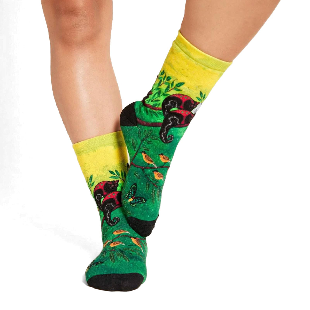 Canopy Encounters by Melanie Hava: yellow and green canopy-print bamboo socks worn on feet, angled view.