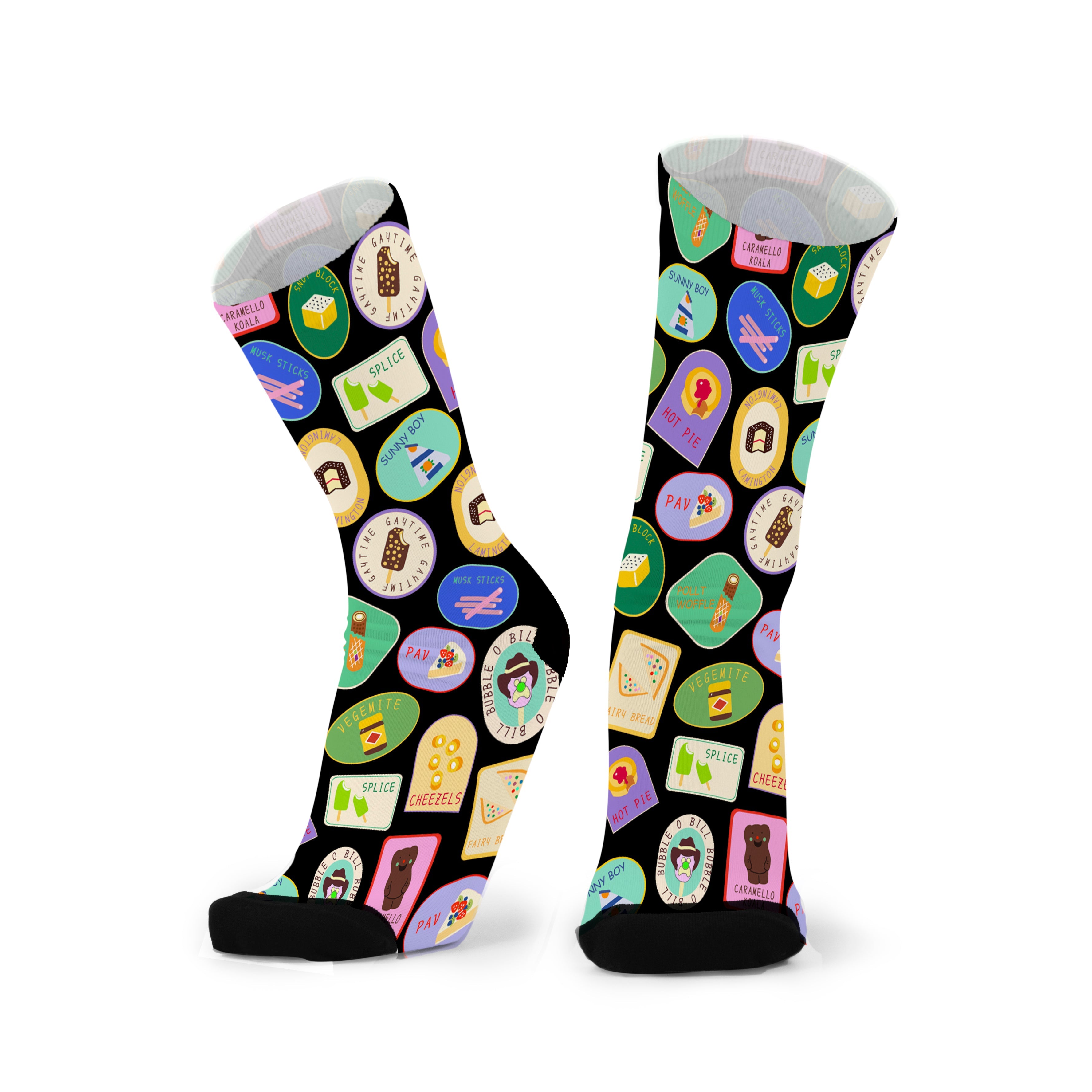 Colourful bamboo socks featuring vegemite, splice, cheezels, lamingtons, golden gaytime, caramello koalas, pavlova, bubble o bill, fairy bread, pies and musk sticks on a black background.