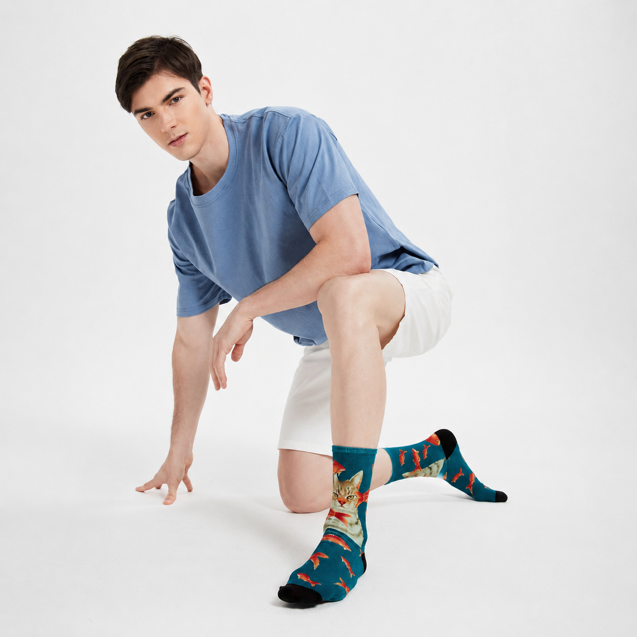 Person wearing colorful socks with a cat design on a white background