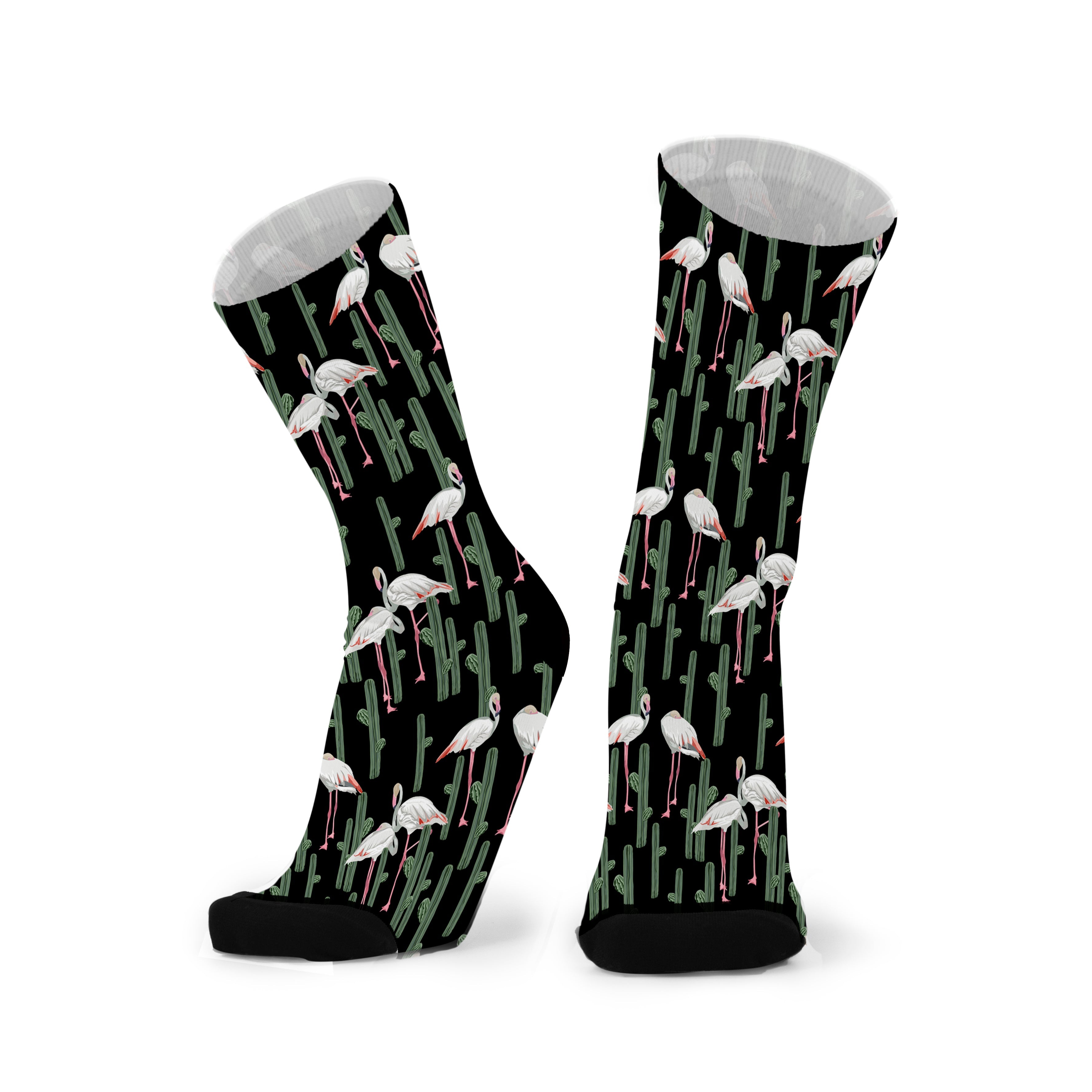 Colourful bamboo socks featuring flamingos and cactus on a black background.