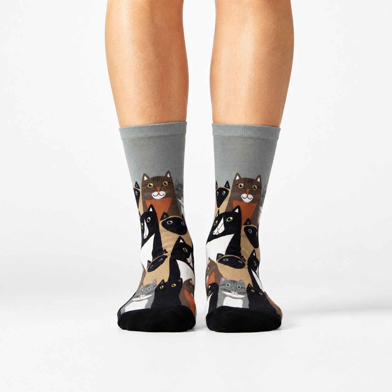 Cat-themed socks worn by a person on a white background