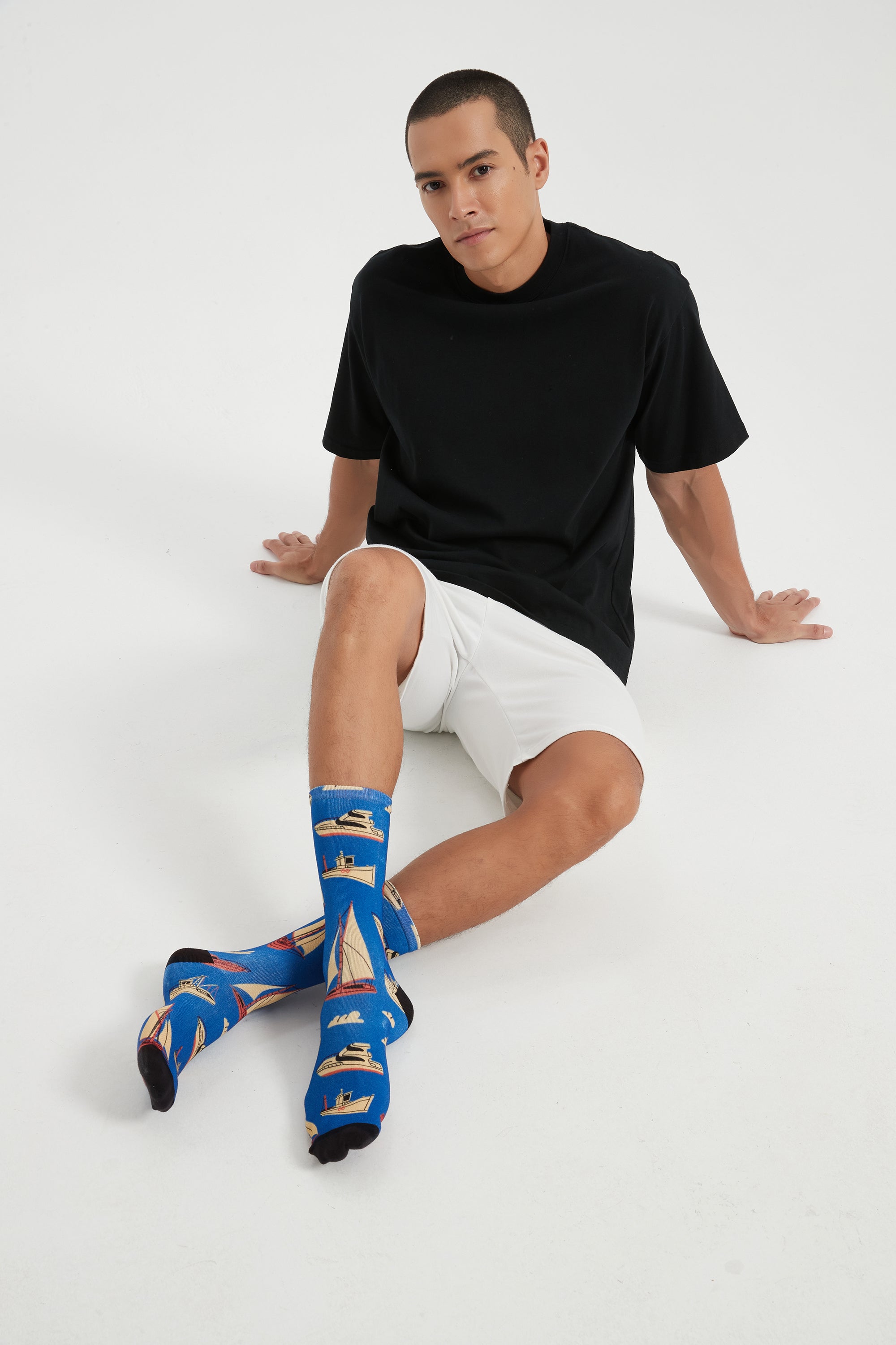 Colourful bamboo socks featuring ships and boats on a blue background.