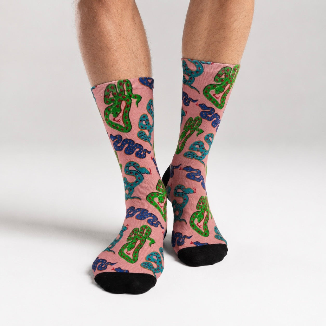 Socks with snake pattern on a pink background